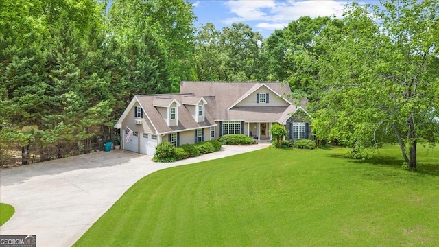 view of front facade with concrete driveway, an attached garage, and a front lawn