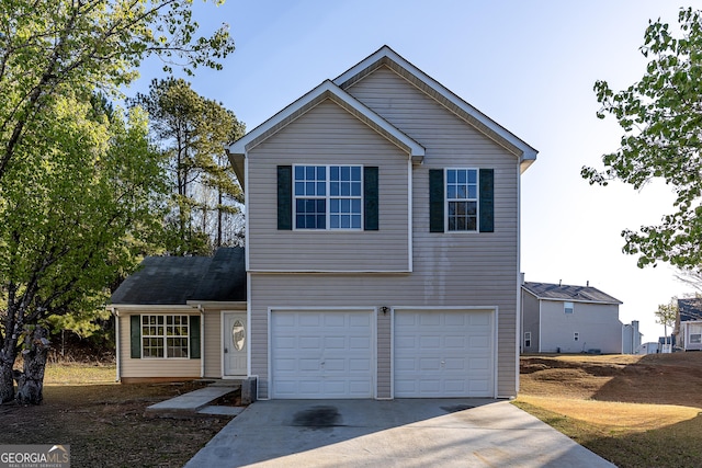 traditional-style house featuring a garage and concrete driveway