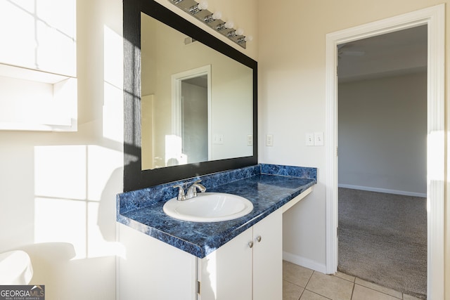 bathroom featuring tile patterned floors, vanity, and baseboards