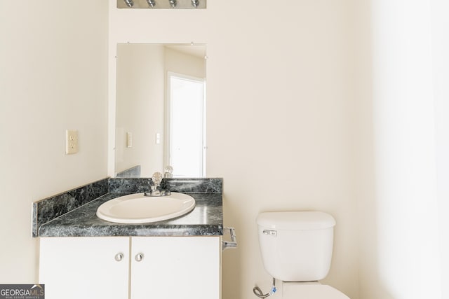 half bathroom featuring toilet and vanity