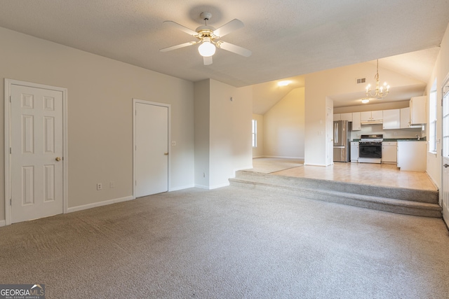 unfurnished living room with vaulted ceiling, light carpet, a textured ceiling, ceiling fan with notable chandelier, and visible vents