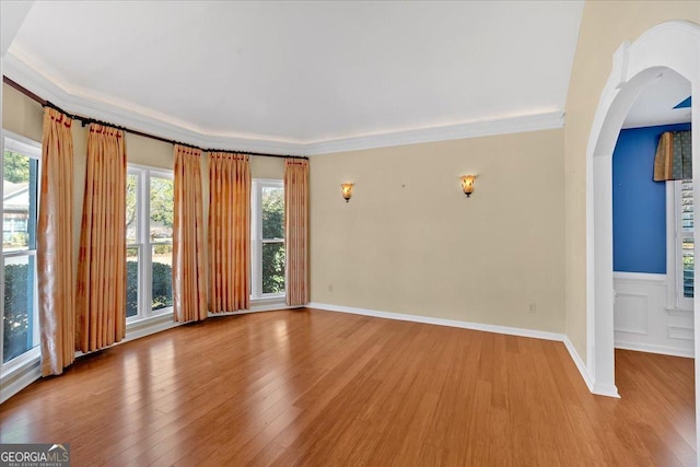 2445 Ridgelake Dr, Villa Rica, GA 30180 - spare room with wood finished floors, arched walkways, and ornamental molding