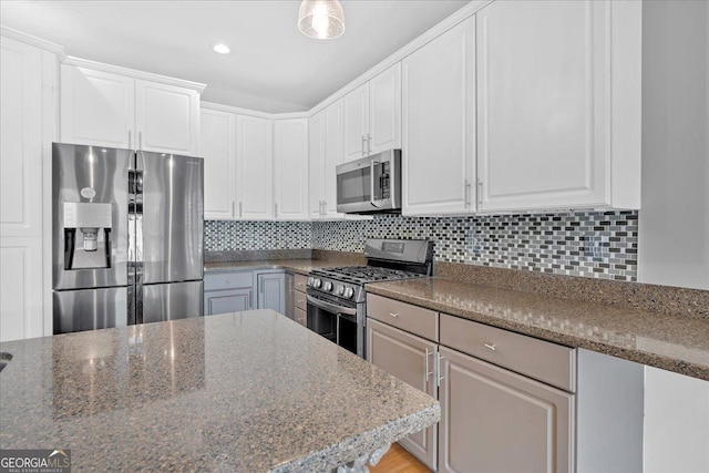 2445 Ridgelake Dr, Villa Rica, GA 30180 - kitchen featuring stainless steel appliances, tasteful backsplash, white cabinetry, and recessed lighting