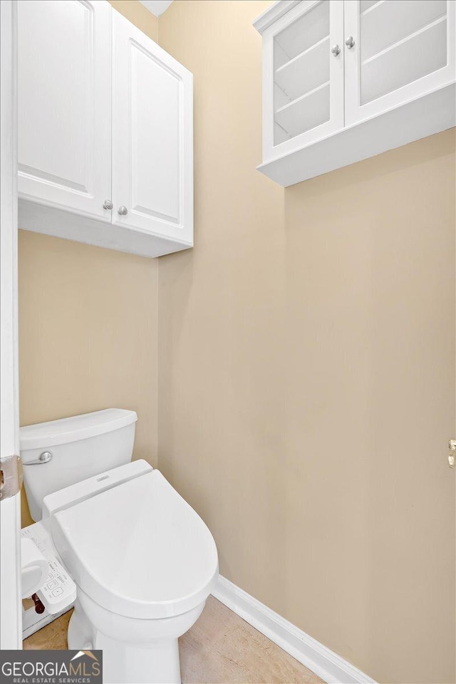 2445 Ridgelake Dr, Villa Rica, GA 30180 - bathroom with toilet and baseboards
