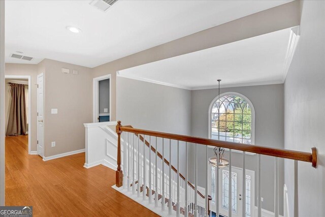 2445 Ridgelake Dr, Villa Rica, GA 30180 - hall featuring an upstairs landing, wood finished floors, crown molding, and recessed lighting