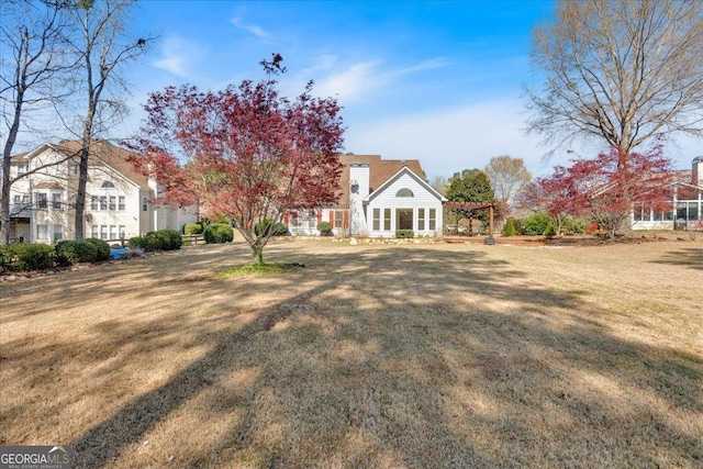 2445 Ridgelake Dr, Villa Rica, GA 30180 - rear view of house featuring a pergola and a lawn