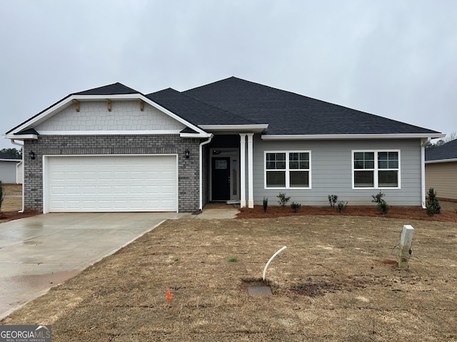 ranch-style home featuring concrete driveway, an attached garage, and a shingled roof