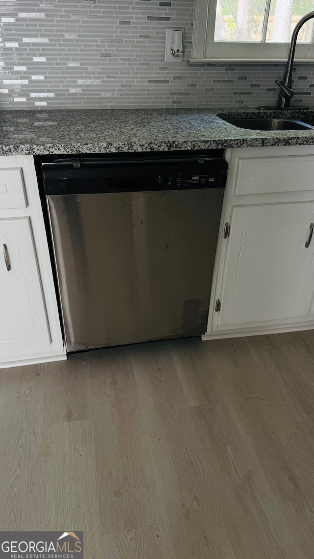 1655 Cherry Hill Rd SW, Conyers, GA 30094 - details with a sink, light wood-type flooring, white cabinetry, decorative backsplash, and dishwasher