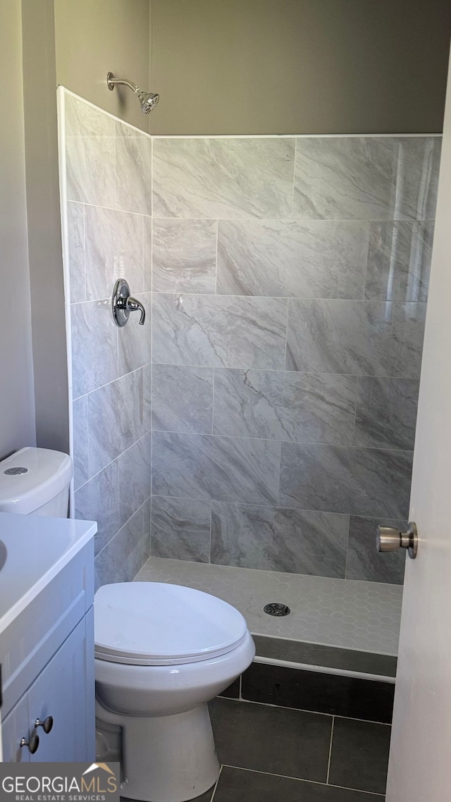 1655 Cherry Hill Rd SW, Conyers, GA 30094 - full bath with tile patterned flooring, toilet, and tiled shower