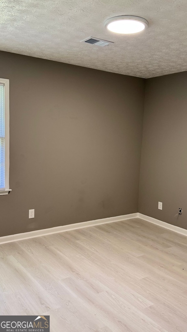 1655 Cherry Hill Rd SW, Conyers, GA 30094 - spare room featuring visible vents, a textured ceiling, and light wood finished floors