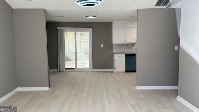 1655 Cherry Hill Rd SW, Conyers, GA 30094 - interior space featuring tasteful backsplash, light wood-style floors, dishwasher, white cabinets, and visible vents