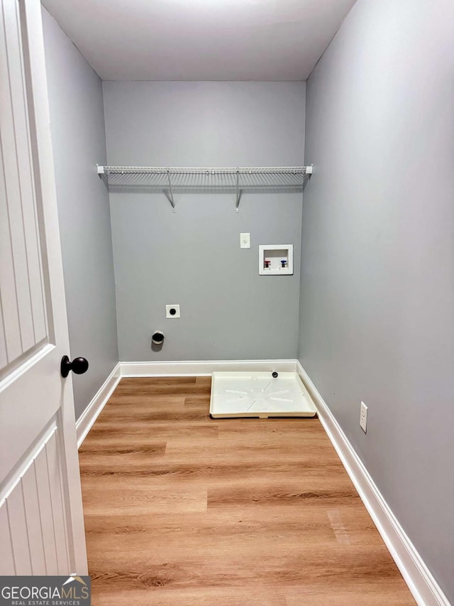 washroom featuring hookup for a washing machine, wood finished floors, laundry area, and electric dryer hookup
