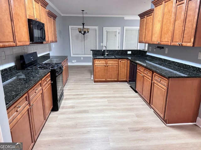kitchen with crown molding, a peninsula, brown cabinetry, black appliances, and light wood-style floors