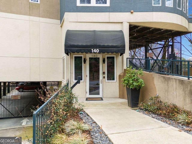 view of exterior entry featuring stucco siding