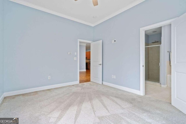 unfurnished bedroom with baseboards, crown molding, carpet floors, and a ceiling fan