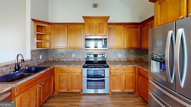 kitchen featuring a sink, appliances with stainless steel finishes, open shelves, and brown cabinets