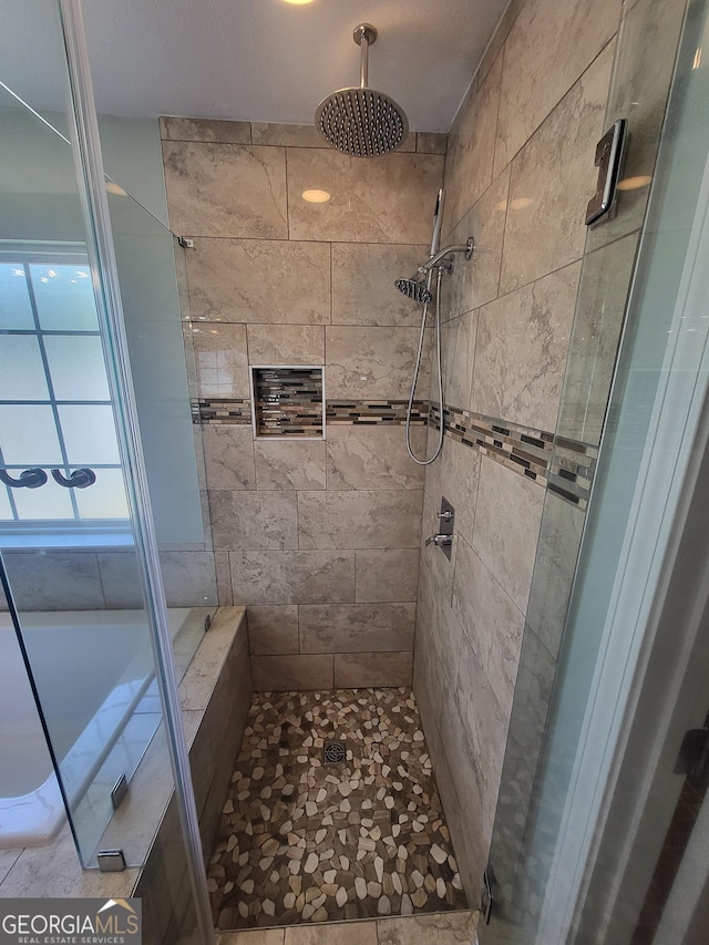 bathroom featuring a tile shower