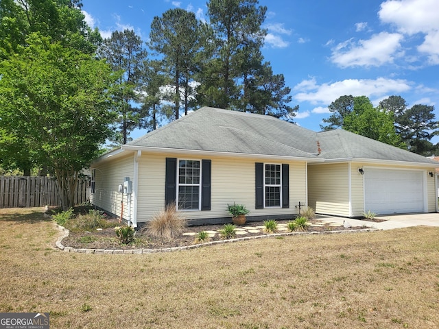 single story home featuring an attached garage, fence, driveway, and a front yard