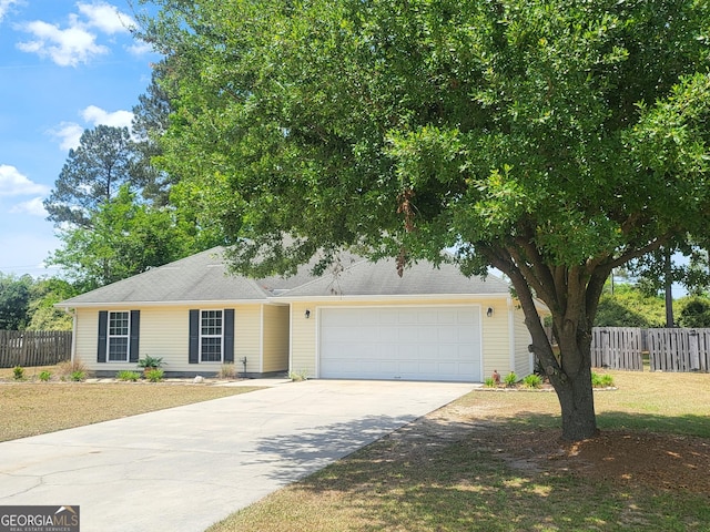 single story home with fence, an attached garage, driveway, and a front lawn