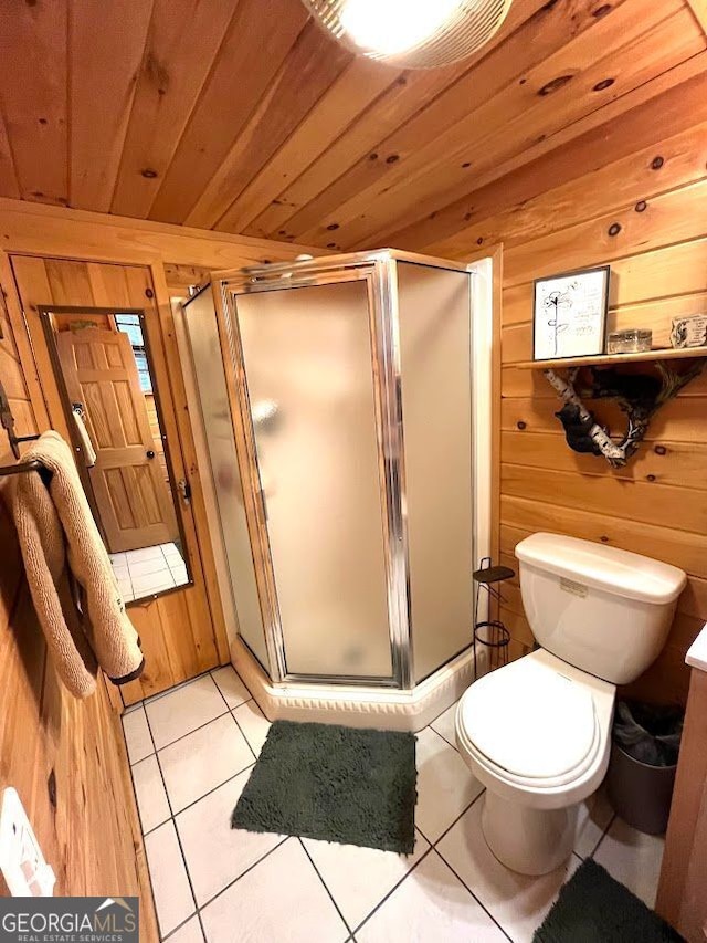 41 Speckled Trout Dr, Cleveland, GA 30528 - bathroom featuring wooden walls, wooden ceiling, a shower stall, tile patterned flooring, and toilet
