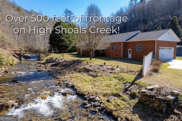 1631 Moody Holw, Hiawassee, GA 30546 - view of side of home featuring a yard, brick siding, an attached garage, and concrete driveway