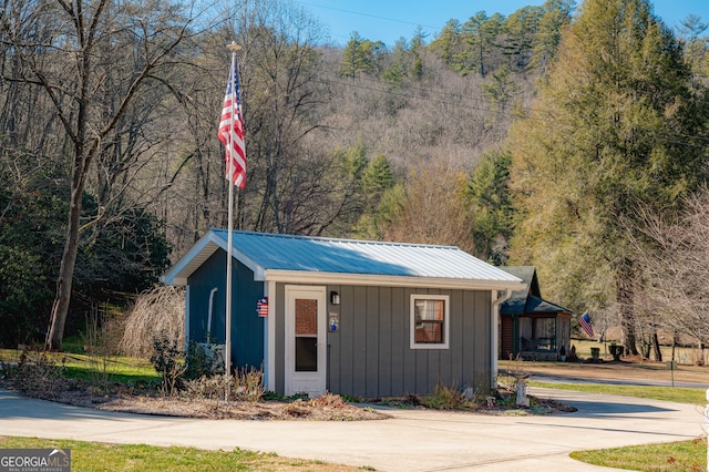 1631 Moody Holw, Hiawassee, GA 30546 - view of outdoor structure featuring concrete driveway and a forest view
