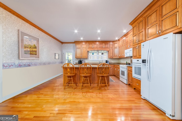 1631 Moody Holw, Hiawassee, GA 30546 - kitchen with a kitchen breakfast bar, wallpapered walls, light wood-style floors, ornamental molding, and white appliances