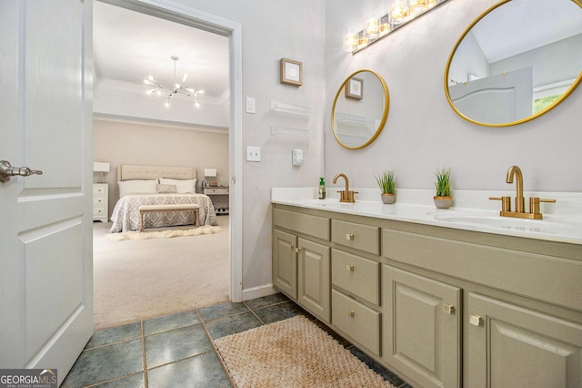 ensuite bathroom with a sink, baseboards, ensuite bathroom, and double vanity