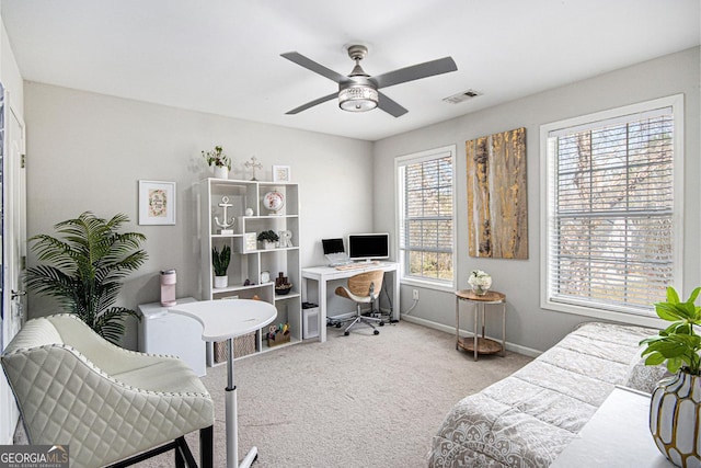 interior space featuring baseboards, ceiling fan, and visible vents