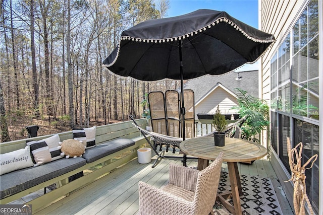 deck with outdoor dining area