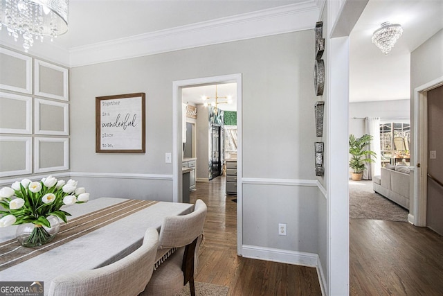 office area with crown molding, baseboards, dark wood-style floors, and a notable chandelier