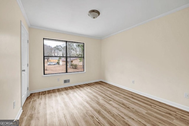 8443 Park Ridge Ln, Riverdale, GA 30274 - spare room featuring wood finished floors, ornamental molding, baseboards, and visible vents
