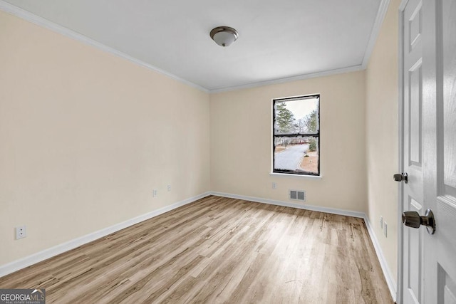 8443 Park Ridge Ln, Riverdale, GA 30274 - spare room with light wood-style flooring, ornamental molding, baseboards, and visible vents