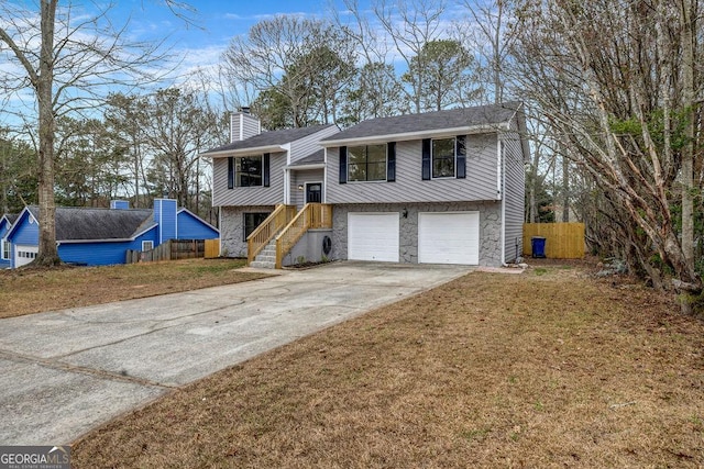 8443 Park Ridge Ln, Riverdale, GA 30274 - raised ranch with fence, stone siding, driveway, a garage, and a chimney