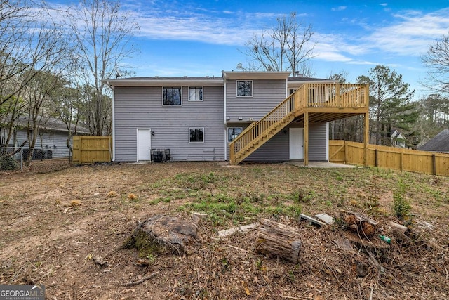 8443 Park Ridge Ln, Riverdale, GA 30274 - back of house featuring a fenced backyard, stairway, central air condition unit, and a wooden deck