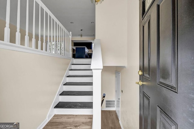 8443 Park Ridge Ln, Riverdale, GA 30274 - stairs featuring baseboards, visible vents, and wood finished floors