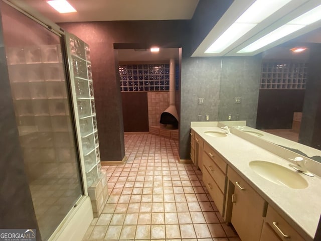 608 Pine Point Ct, Valdosta, GA 31602 - bathroom featuring double vanity, a sink, and walk in shower