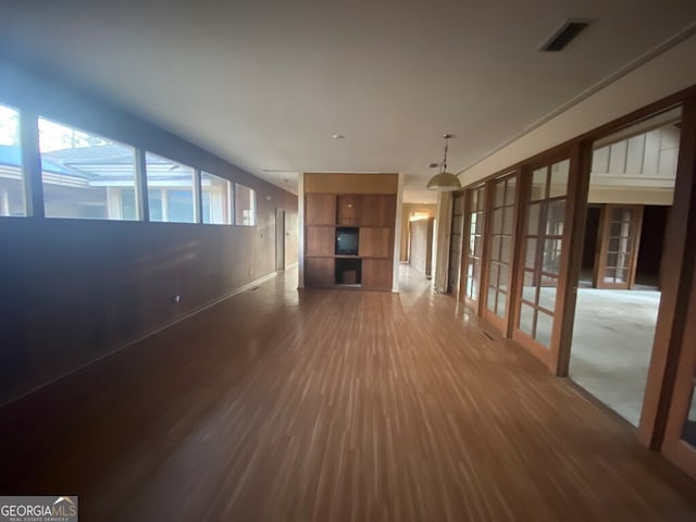 608 Pine Point Ct, Valdosta, GA 31602 - unfurnished living room featuring french doors, wood finished floors, baseboards, and visible vents
