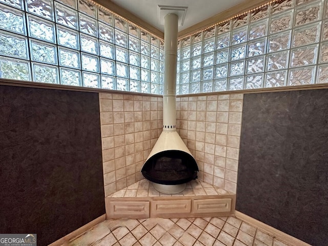 608 Pine Point Ct, Valdosta, GA 31602 - bathroom featuring baseboards, a wood stove, and tile patterned flooring