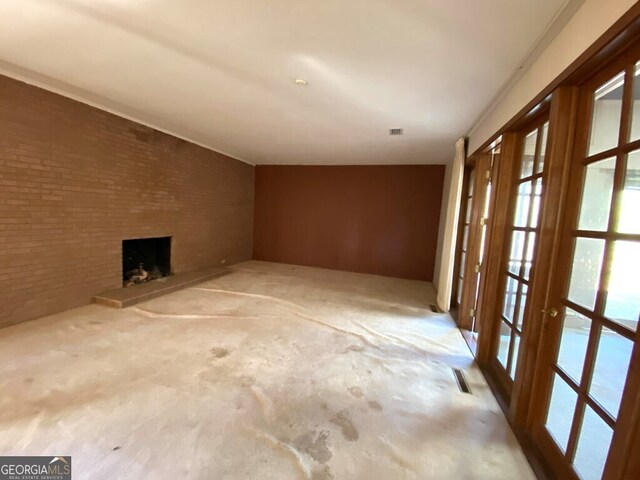608 Pine Point Ct, Valdosta, GA 31602 - interior space featuring a fireplace, visible vents, light carpet, and brick wall