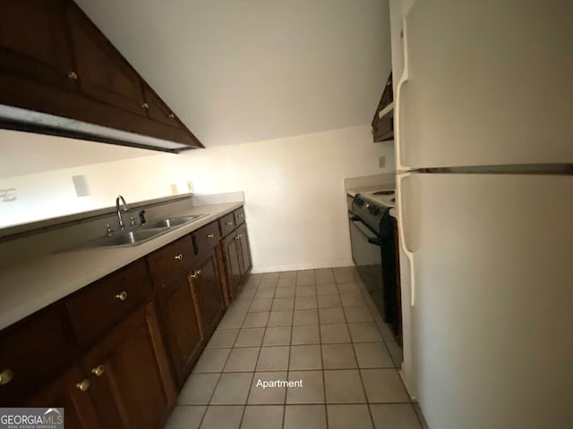 608 Pine Point Ct, Valdosta, GA 31602 - kitchen featuring light countertops, black range with electric stovetop, a sink, vaulted ceiling, and freestanding refrigerator