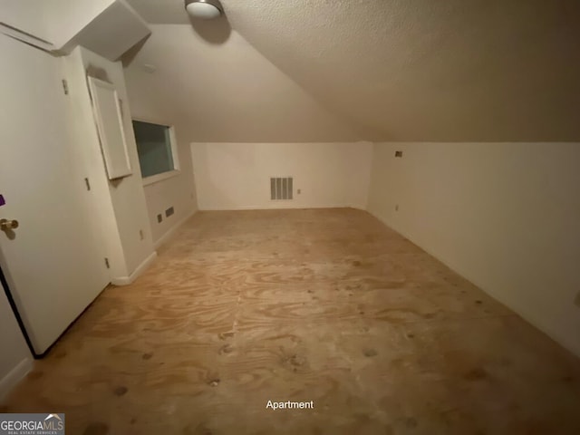 608 Pine Point Ct, Valdosta, GA 31602 - bonus room featuring light carpet, a textured ceiling, vaulted ceiling, and visible vents