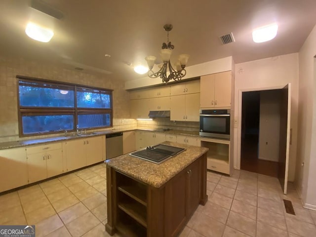 608 Pine Point Ct, Valdosta, GA 31602 - kitchen featuring under cabinet range hood, a chandelier, light tile patterned flooring, visible vents, and appliances with stainless steel finishes