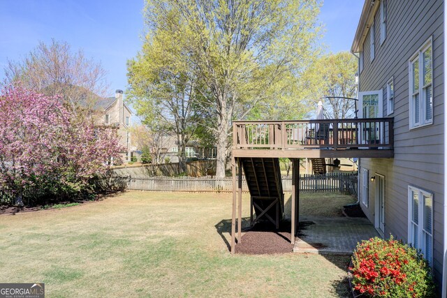 view of yard featuring a deck and fence