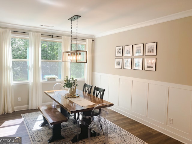 5745 Pickens Garden Ln, Powder Springs, GA 30127 - dining area featuring dark wood-style floors, a decorative wall, ornamental molding, a chandelier, and wainscoting