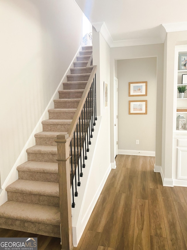 5745 Pickens Garden Ln, Powder Springs, GA 30127 - stairway with crown molding and wood finished floors