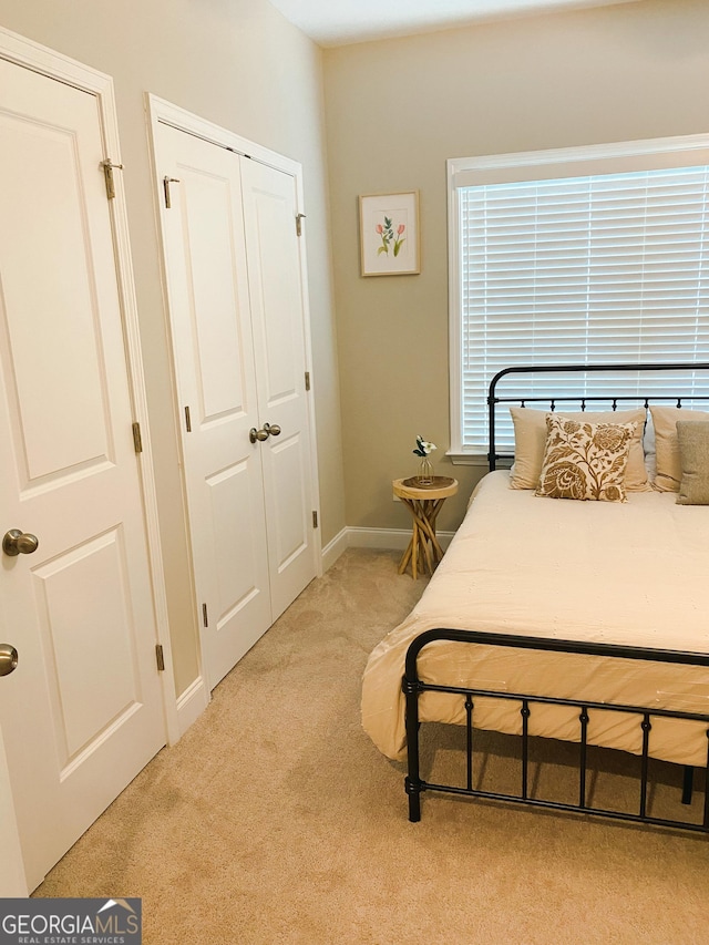 5745 Pickens Garden Ln, Powder Springs, GA 30127 - carpeted bedroom with a closet and baseboards