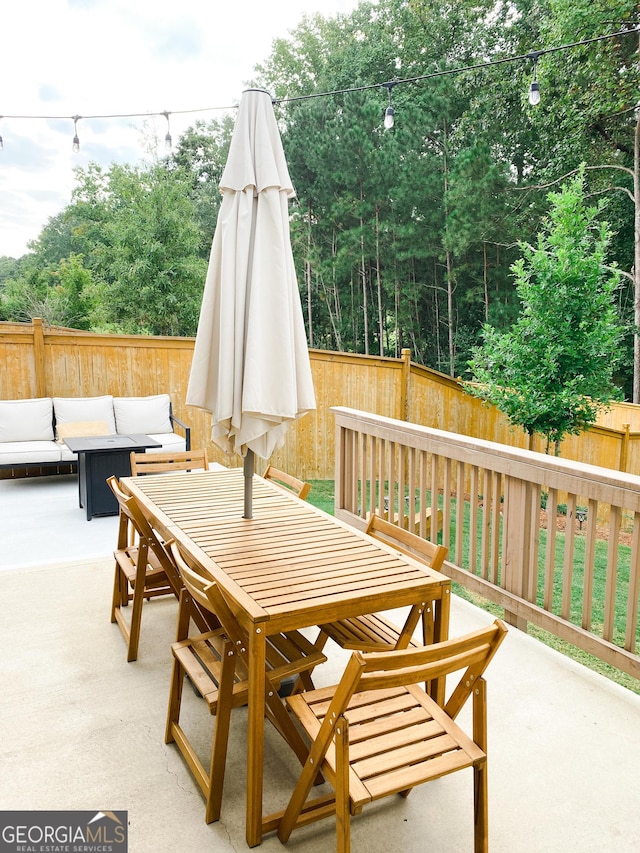 5745 Pickens Garden Ln, Powder Springs, GA 30127 - fenced backyard featuring outdoor dining space, a patio, and an outdoor hangout area