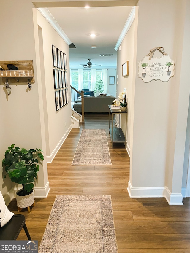 5745 Pickens Garden Ln, Powder Springs, GA 30127 - hallway featuring crown molding, wood finished floors, and stairs