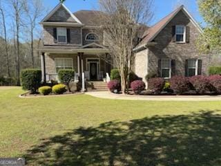 711 Lily Glen Ln, Stockbridge, GA 30281 - traditional home with a porch and a front lawn